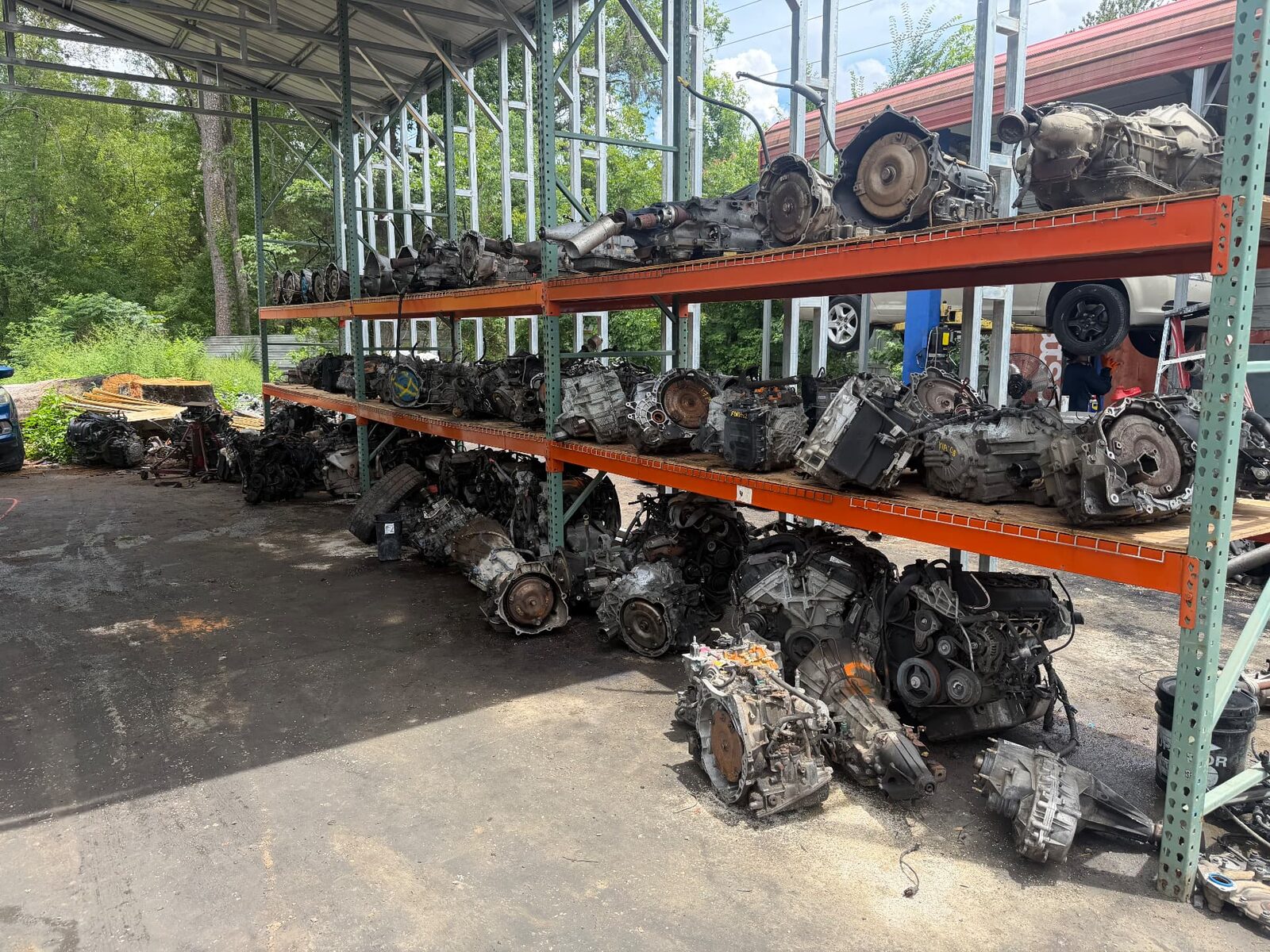 Shelves of used auto parts, engines, wheels and headlights in our warehouse